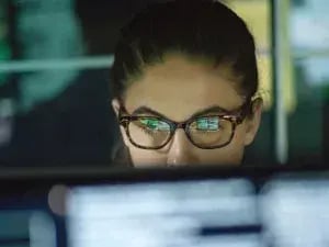 House Analogy Series: BMS System – Datto RMM woman sitting and monitoring